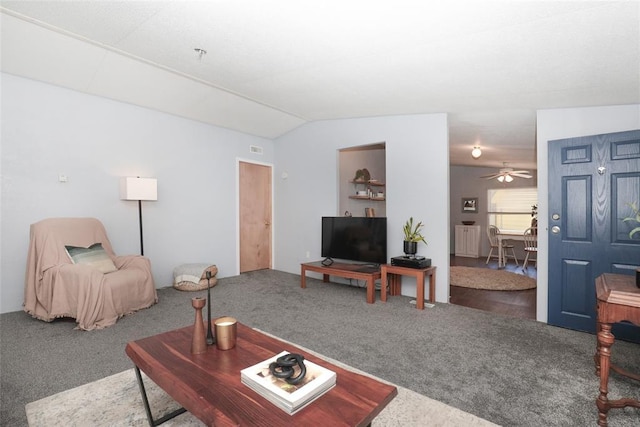 living room with ceiling fan, carpet floors, radiator, and lofted ceiling