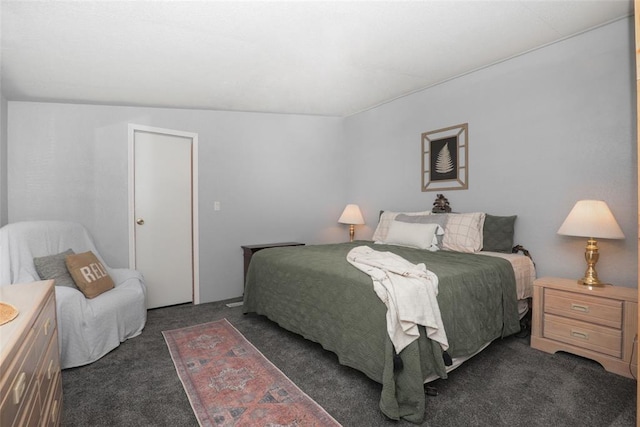 bedroom featuring dark carpet and vaulted ceiling