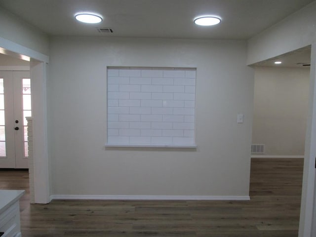 foyer featuring baseboards, visible vents, wood finished floors, and french doors