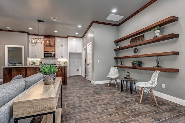 kitchen with white cabinets, decorative light fixtures, decorative backsplash, and ornamental molding