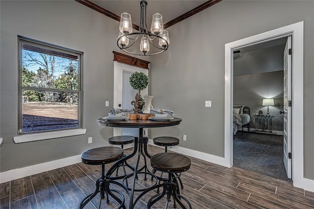 dining space with a notable chandelier and ornamental molding