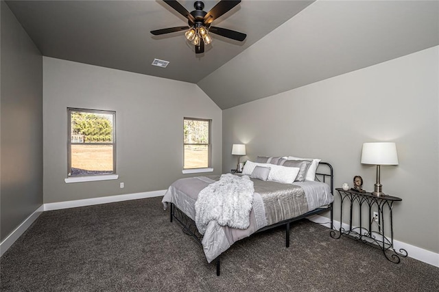 bedroom featuring ceiling fan, dark carpet, lofted ceiling, and multiple windows