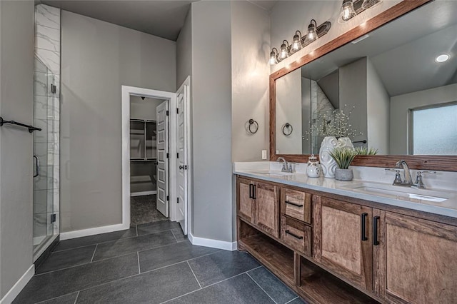 bathroom featuring tile patterned flooring, vanity, and walk in shower