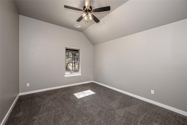 carpeted empty room with vaulted ceiling and ceiling fan