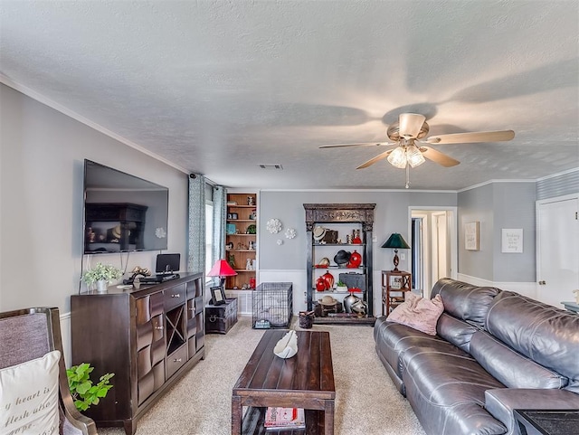 living room with a textured ceiling, light colored carpet, and ceiling fan