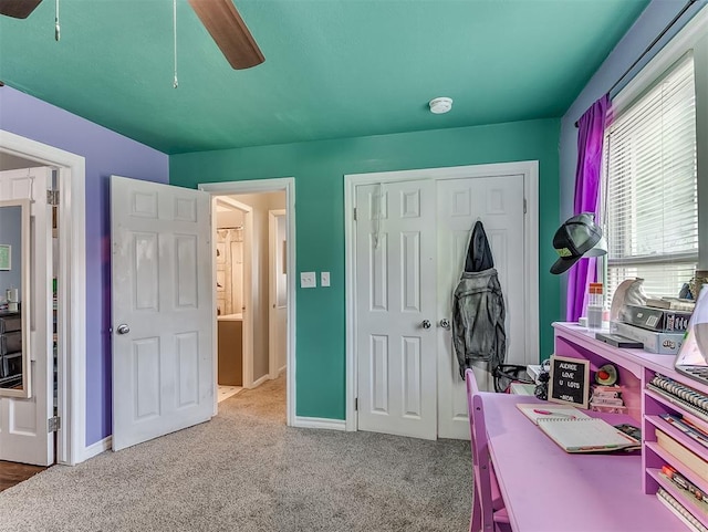 office space with light colored carpet and ceiling fan