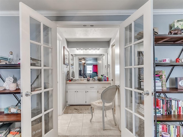 bathroom with tile patterned flooring, vanity, crown molding, and french doors