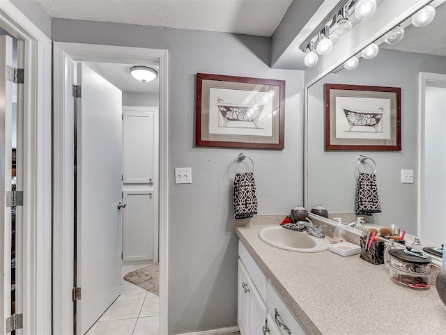 bathroom featuring tile patterned flooring and vanity