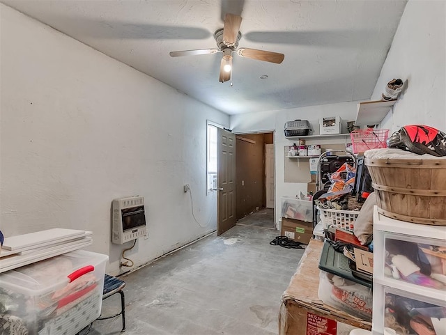 interior space featuring heating unit and ceiling fan