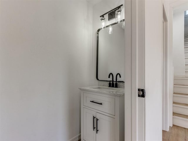 bathroom with hardwood / wood-style floors and vanity