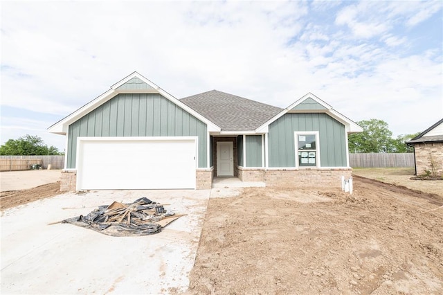 1921 Taines Turn, Norman, OK 73072 - view of front of property with board and batten siding, roof with shingles, a garage, and brick siding