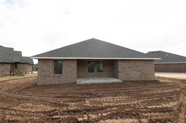 1921 Taines Turn, Norman, OK 73072 - rear view of house with a patio area, brick siding, and roof with shingles