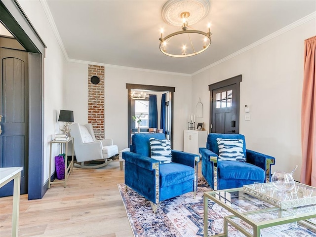 living area featuring ornamental molding, a wealth of natural light, a chandelier, and light hardwood / wood-style floors