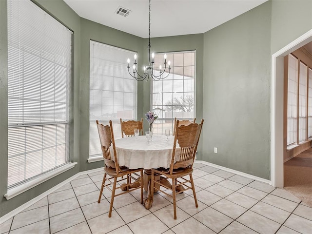 tiled dining space with an inviting chandelier