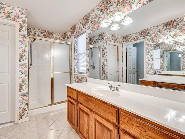 bathroom with tile patterned floors, vanity, and walk in shower