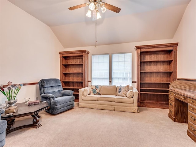 carpeted living room featuring ceiling fan and vaulted ceiling