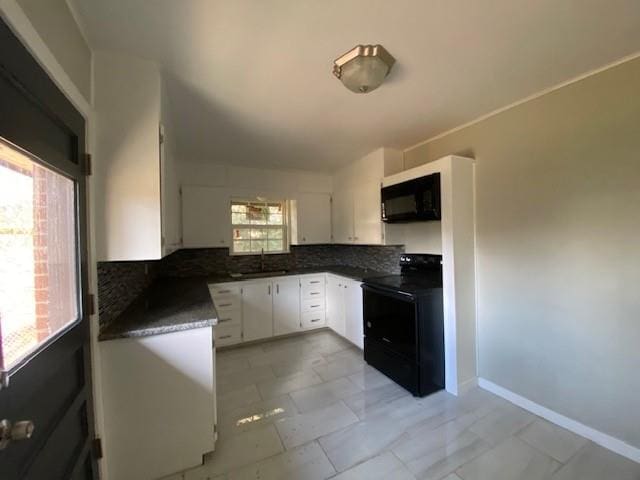 kitchen with decorative backsplash, white cabinetry, sink, and black appliances