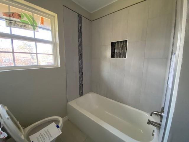 bathroom with tile patterned floors, a healthy amount of sunlight, and shower / bathtub combination