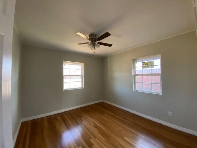 empty room featuring ceiling fan and hardwood / wood-style floors