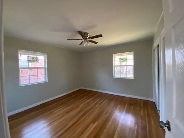 spare room featuring dark hardwood / wood-style flooring and ceiling fan