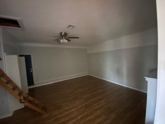 unfurnished room with ceiling fan and dark hardwood / wood-style floors