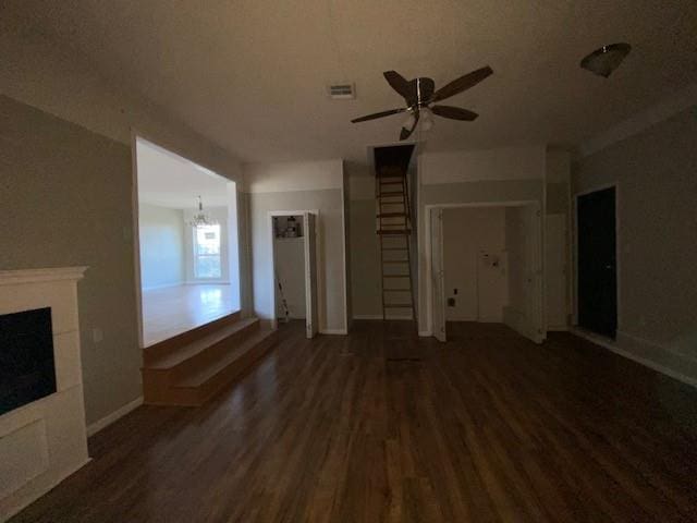 unfurnished living room with ceiling fan, dark hardwood / wood-style floors, and a fireplace