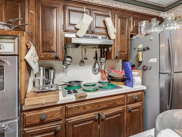 kitchen with stainless steel fridge and white stovetop