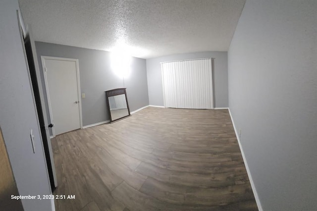 interior space with hardwood / wood-style flooring and a textured ceiling