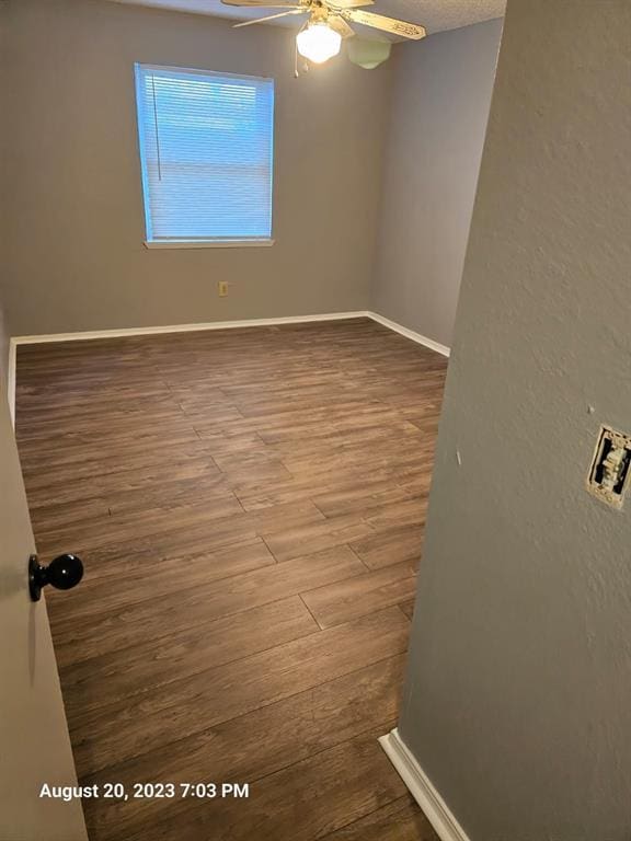 spare room featuring ceiling fan and hardwood / wood-style floors