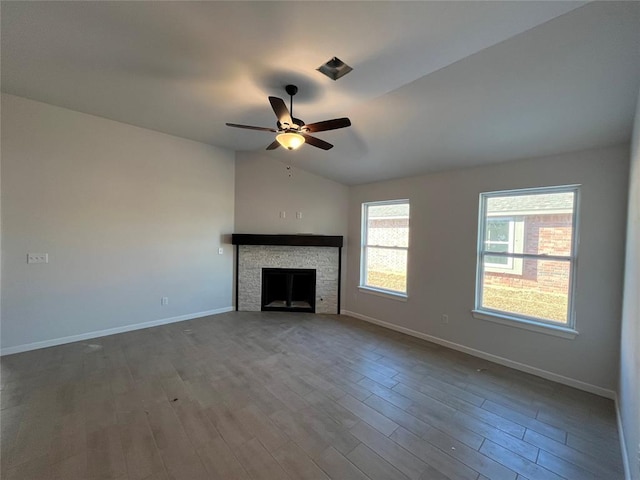 unfurnished living room featuring a fireplace, ceiling fan, lofted ceiling, and hardwood / wood-style floors