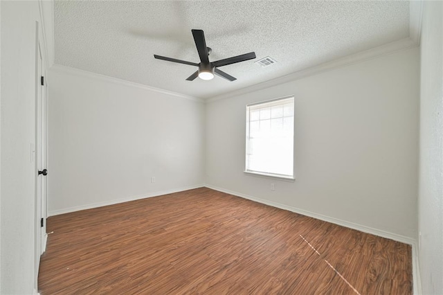 spare room with ceiling fan, dark wood-type flooring, a textured ceiling, and ornamental molding