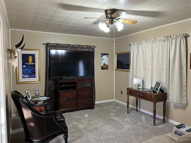 carpeted living room with ceiling fan and ornamental molding