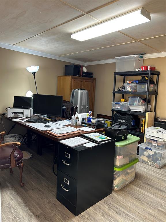 office area featuring light hardwood / wood-style floors and ornamental molding