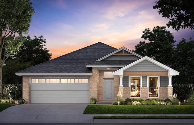 view of front of home featuring a lawn and a garage