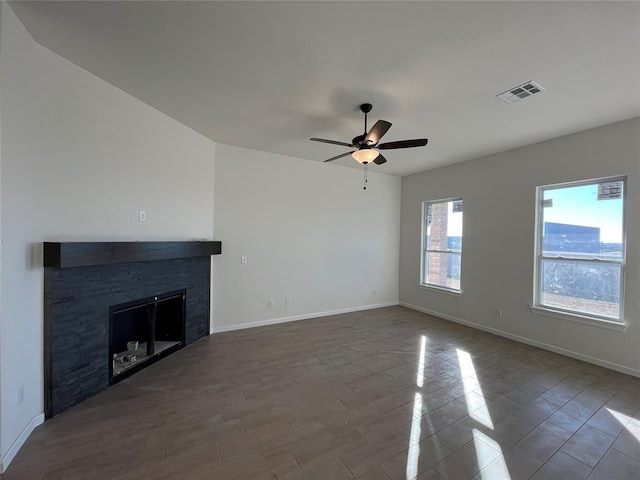 unfurnished living room featuring a fireplace, ceiling fan, and wood-type flooring