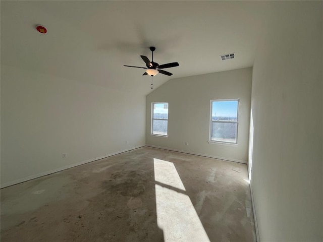 spare room featuring ceiling fan, concrete floors, and vaulted ceiling