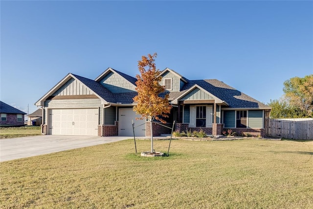 craftsman inspired home featuring a garage and a front lawn