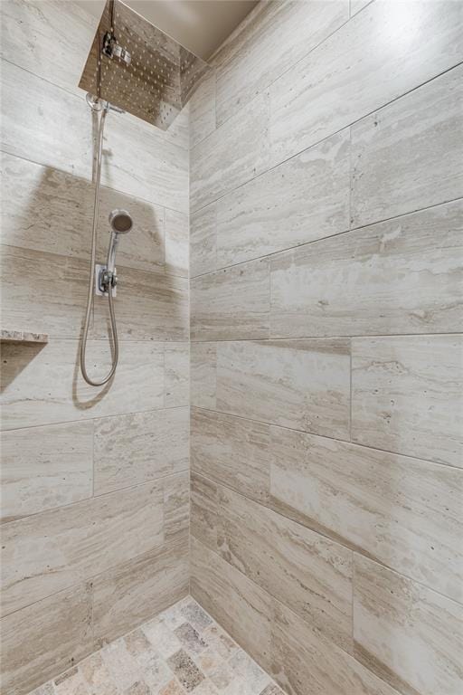 interior details featuring tiled shower