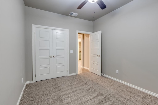 unfurnished bedroom with ceiling fan, a closet, and carpet