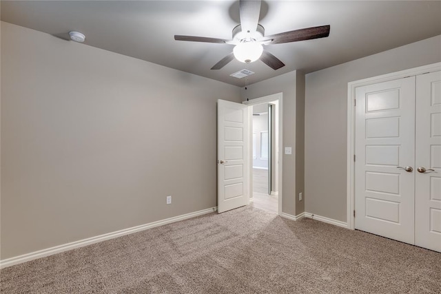 unfurnished bedroom with carpet, ceiling fan, and a closet