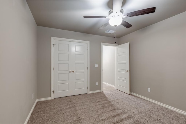 unfurnished bedroom with carpet floors, a closet, and ceiling fan