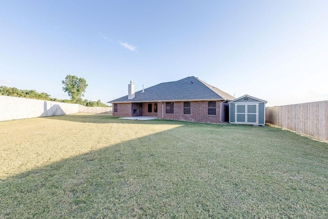 back of property with a lawn, a shed, and a patio