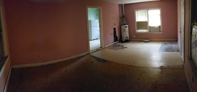 interior space featuring cooling unit, water heater, and baseboards