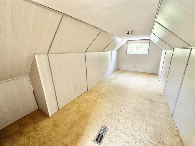 bonus room featuring light carpet and lofted ceiling