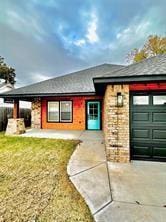 view of front of home with a garage and a front lawn