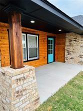 view of exterior entry featuring a porch