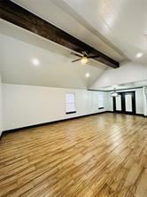 bonus room with ceiling fan, hardwood / wood-style floors, and lofted ceiling with beams