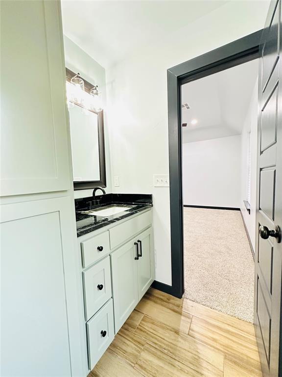 bathroom featuring hardwood / wood-style floors and vanity