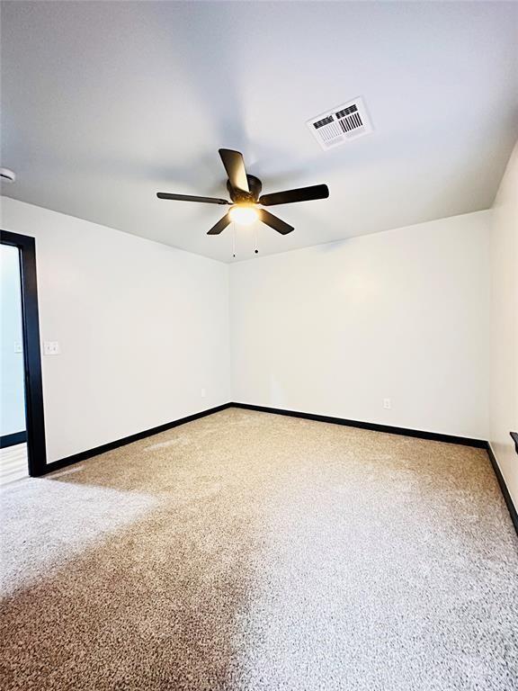 spare room with ceiling fan