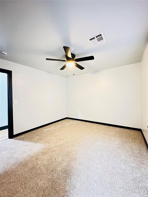 9 SW 24th St, Oklahoma City, OK 73109 - empty room with ceiling fan, light colored carpet, and a smoke detector